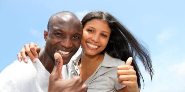 Cheerful Couple Showing Thumbs Up